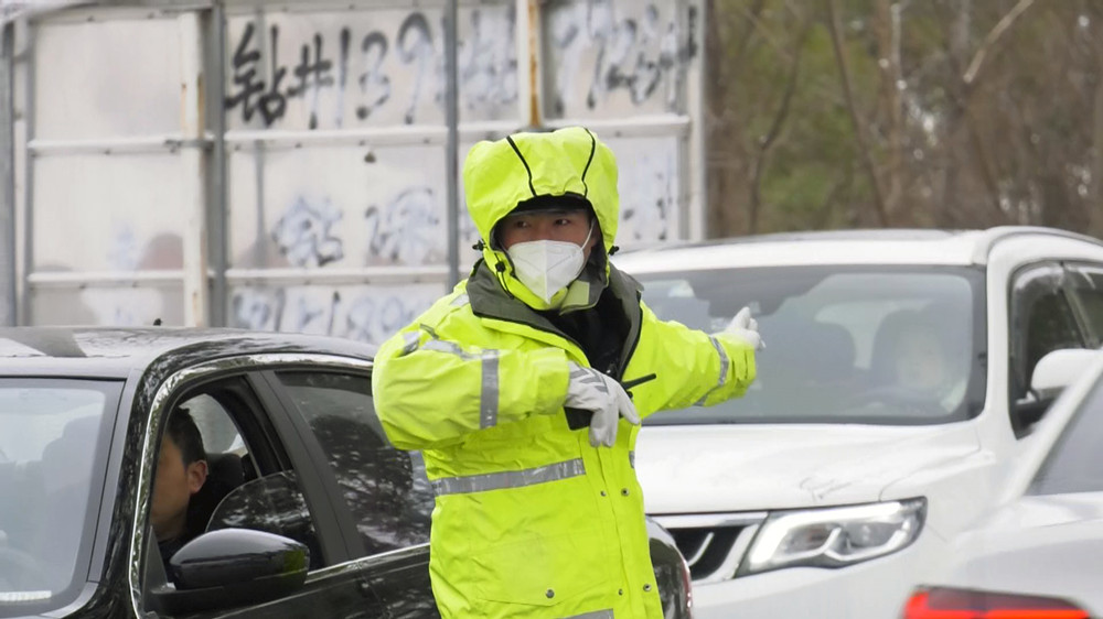 /uploads/image/2023/01/16/c5612a59f0749d42376ff6658948e52e.jpg 图为正在车流中顶风冒雪指挥交通的交警.jpg