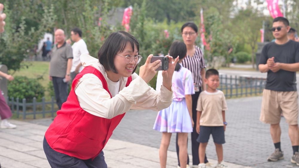 /uploads/image/2025/10/07/a8ec62b4499a1fbe0067463440600b89.jpg 图为志愿者帮助游客拍照._副本.jpg