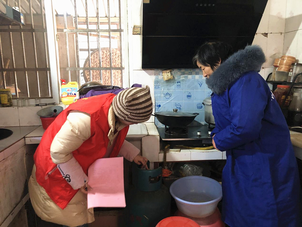 图为工作人员为老人检查燃气灶具_副本.jpg